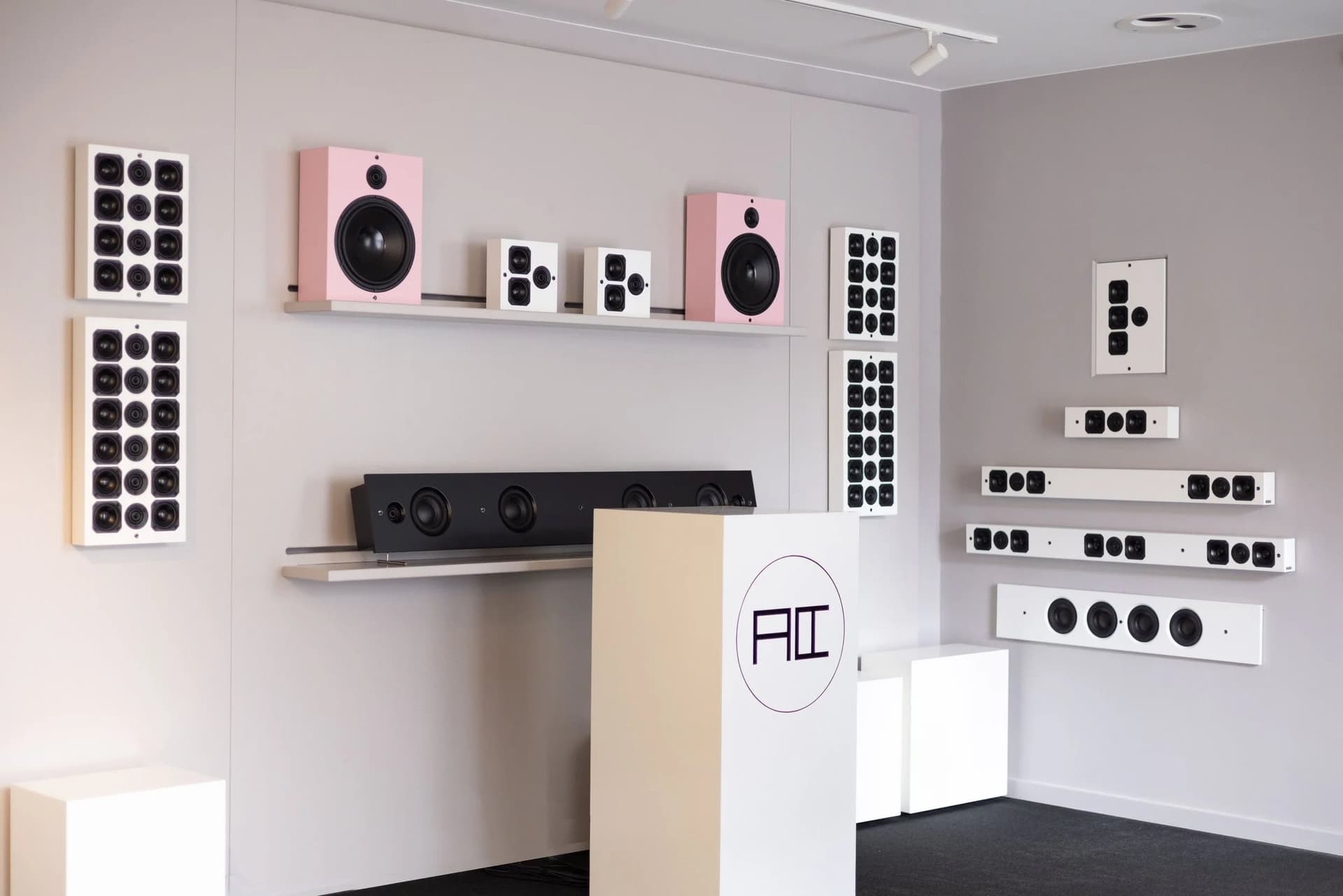 Artcoustic demonstration wall showing speaker modules and screens