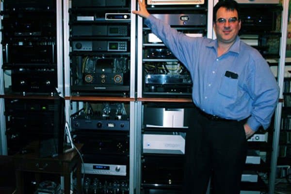 Dave Lalin beside an equipment rack in one of the listening rooms