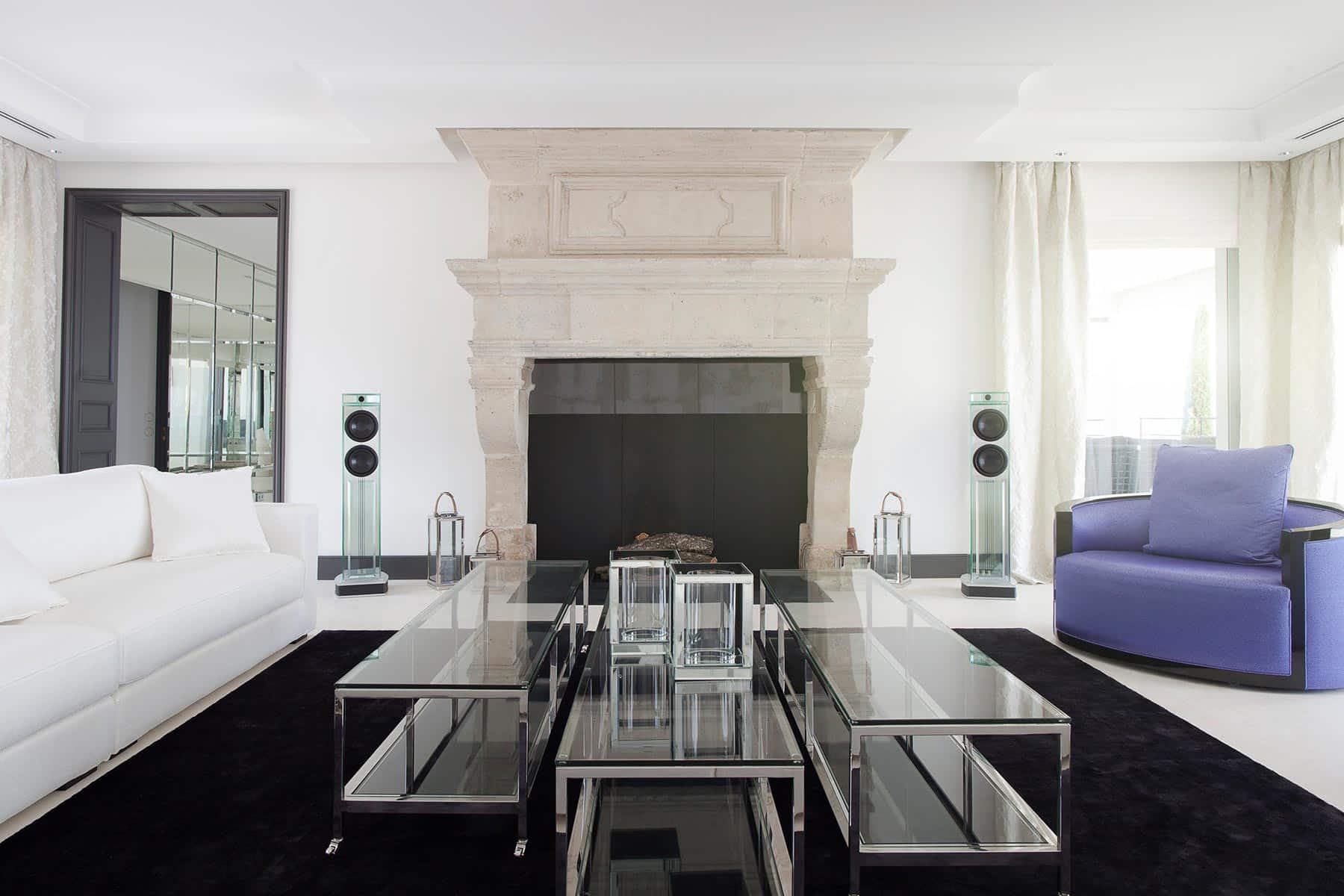 Waterfall Audio Niagara glass loudspeakers beside a fireplace