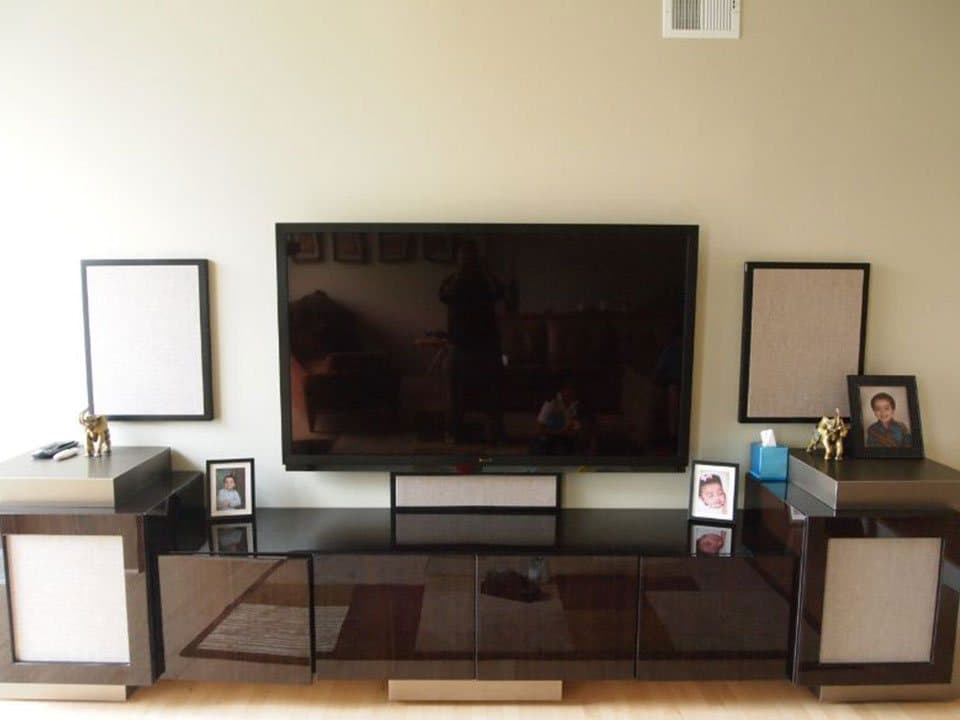 Floating media cabinet with a wall-mounted television and invisible wiring