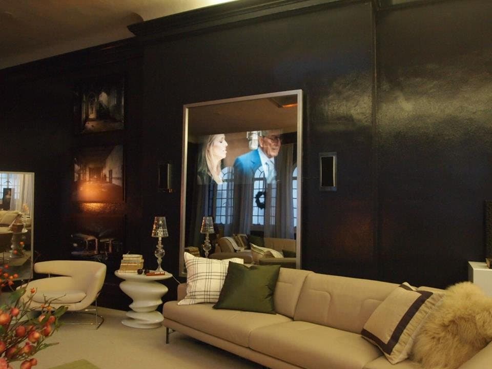 Dark panelled living room with a mirror that conceals a television