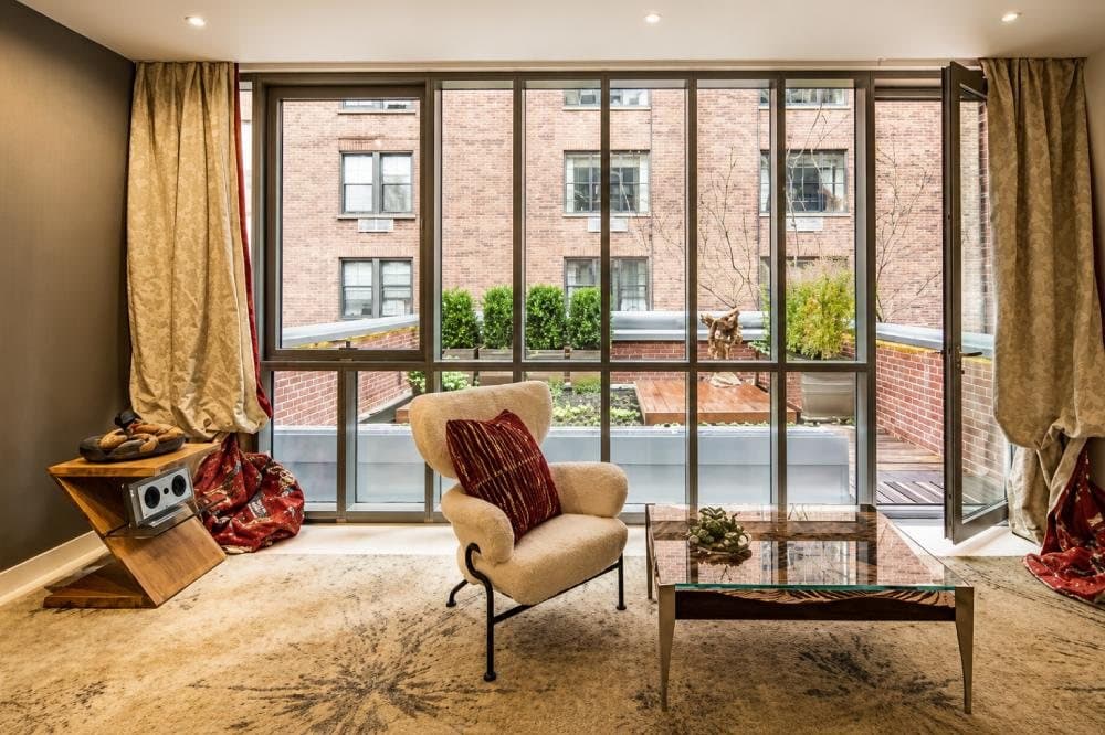 Living room of the Waterfall Mansion with a glass loudspeaker by the window
